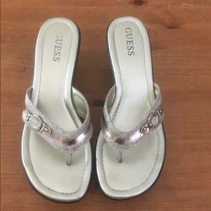 GUESS gold shimmer thong sandals.